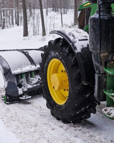 cleaning machine is removing snow from road