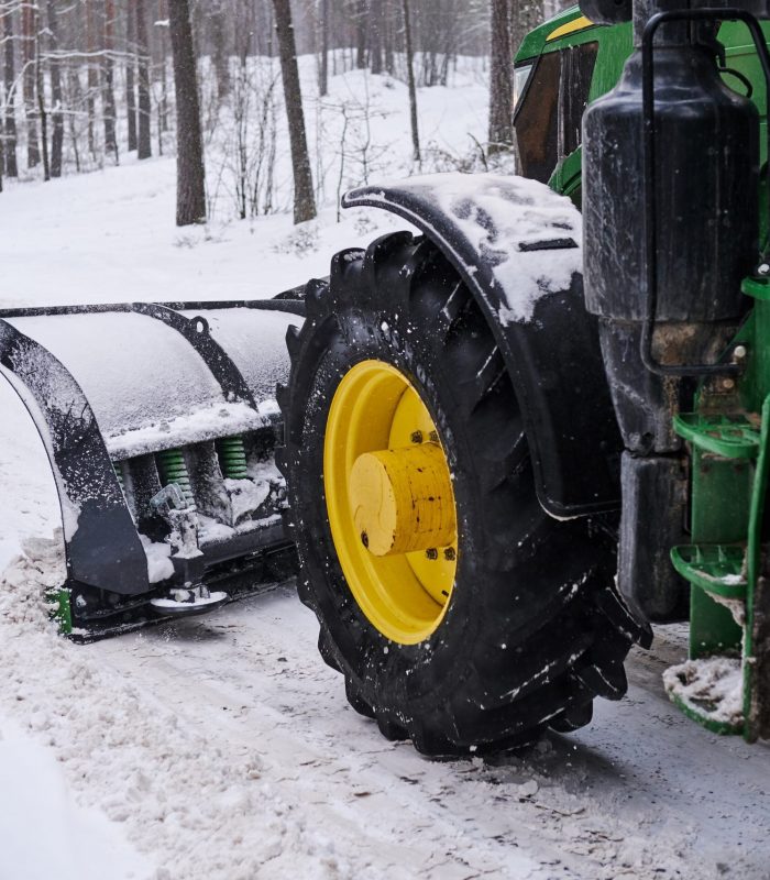 cleaning machine is removing snow from road